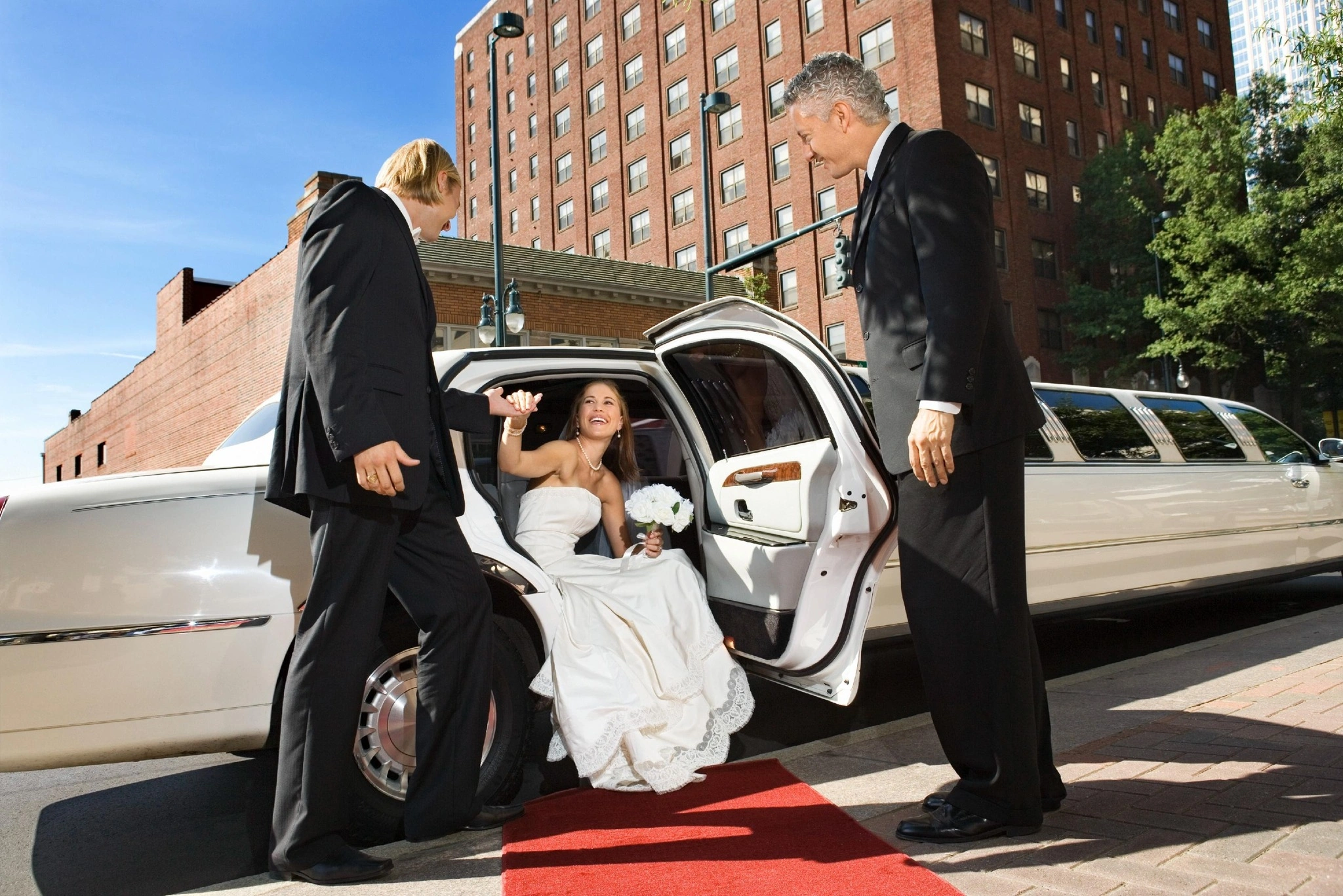Bride arriving in a vintage limousine